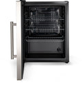 Ein offener, leerer Edelstahl-Backofen mit drei Drahtgestellen und einem Bedienknopf unten rechts - ideal für jede Outdoor-Küche. Sein geräumiger Innenraum entspricht dem des Cozze Kühlschrank 60L mit Stahlrahmen, elektrisch 230V (CH-Stecker).