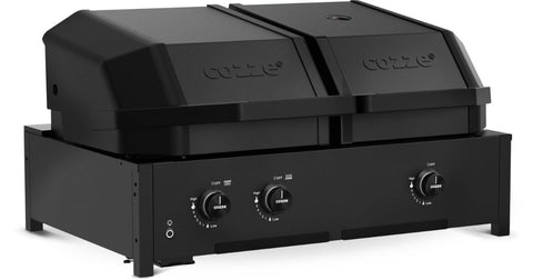 Der Cozze Grill Quattro 900 ist ein schwarzer Zweikammer-Gas-Pizzaofen für den Außenbereich mit zwei Fächern mit Deckel und Bedienknöpfen an der Vorderseite, der für die Verwendung auf dem Tisch konzipiert und mit einem Grill mit Infrarotbrennern kompatibel ist. Betrieben mit Gas (50mbar, CH-Regler).