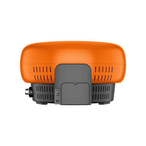 Eine Vorderansicht des kompakten Everdure KILN-Gaspizzaofens mit einem leuchtend orangefarbenen Finish, ideal für Pizzaliebhaber. Er verfügt über eine glatte, abgerundete Oberseite und einen grauen Sockel mit Lüftungsschlitzen. Das kleine Bedienfeld an der Seite sorgt für ein unvergleichliches Pizzaerlebnis.