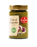 Ein Glas mit „Pizzalovers“ Pesto di Pistacchio in grünlich-brauner Farbe. Auf dem Etikett steht „Pesto di Pistacchio“ und unten ist ein Bild von Bronte-Pistazien zu sehen. Der goldene Deckel ergänzt den grünen Kreis des Etiketts und weist auf „con pistacchio di Sicilia“ hin, was dies zu einer echten Delikatesse macht.